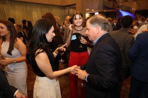 A Blackburn Advisory Board member networks with a Fellow and student
