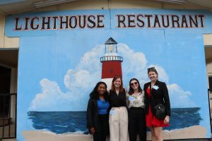 Students pose outside of restaurant