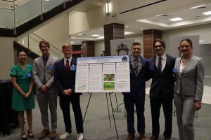 Students presenting the poster "Leaf our Streamside Habitats Alone" at Daniel Community Scholars