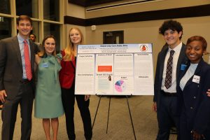 Students presenting the poster "Maternity Care Baby Bins" at Daniel Community Scholars