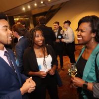 A Blackburn Fellow speaks with two students