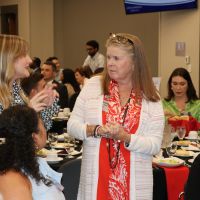 Students chat with and Advisory Board member at dinner